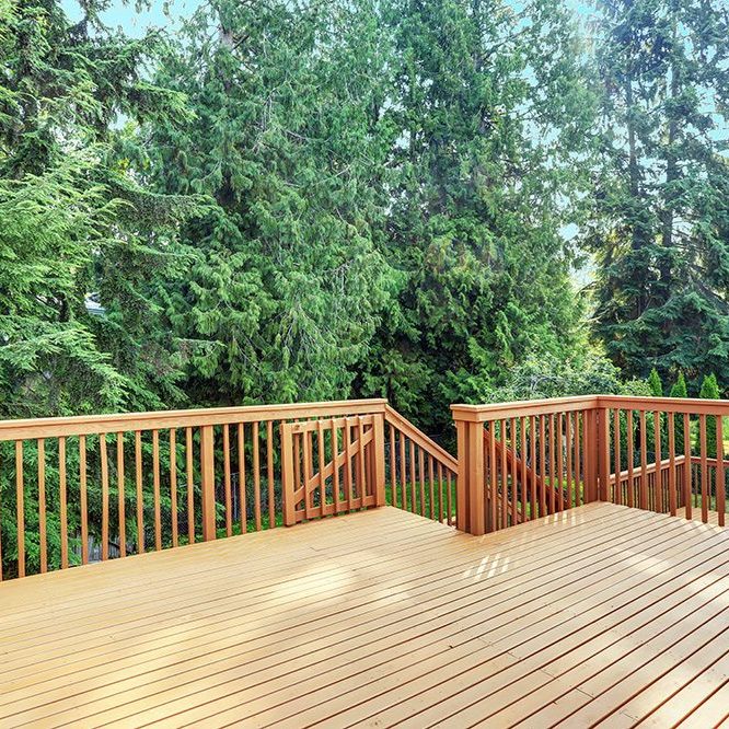 Empty upper level deck boasts redwood railings overlooking the lower level deck.